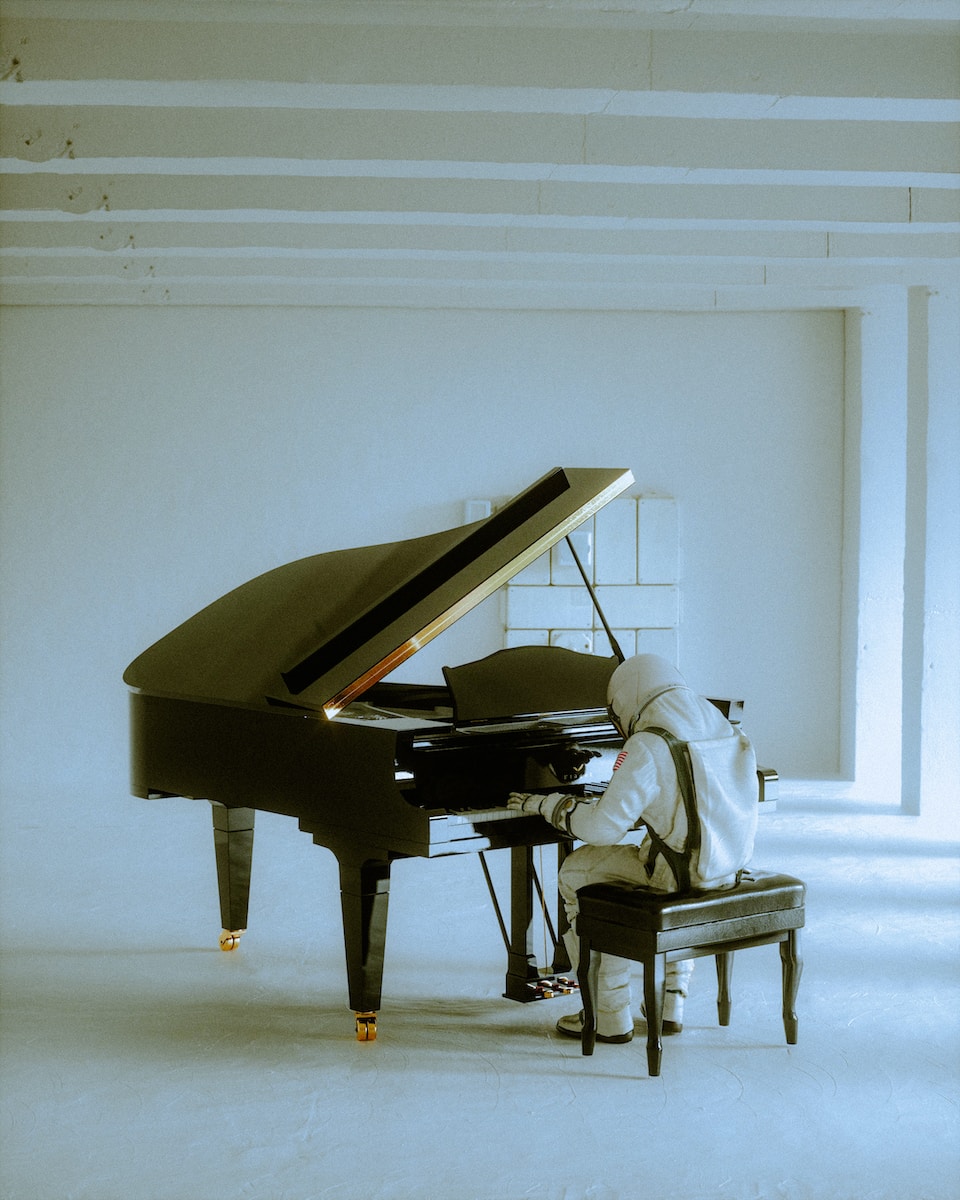 a person sitting at a piano in a room